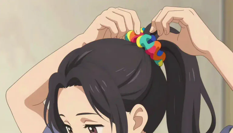 Visual representation of "scrunchie" - A scrunchie is a hair accessory made of fabric that is used to fasten hair in a ponytail or bun.