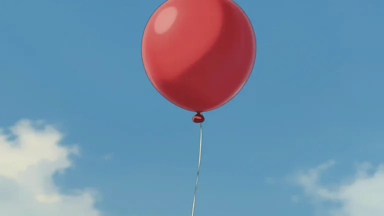 Visual representation of "balloon" - A large round bag, often with a string attached, that is filled with hot air or gas and floats in the air