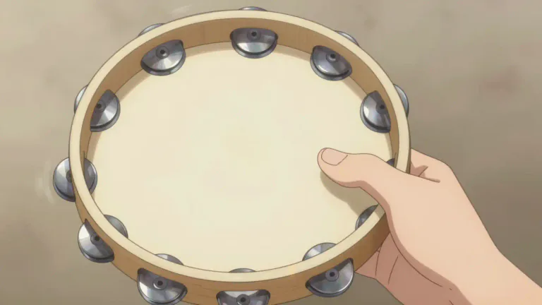 Visual representation of "tambourine" - A musical instrument that you shake or hit with your hand. It is round and usually has metal pieces attached around the edge to make noise.