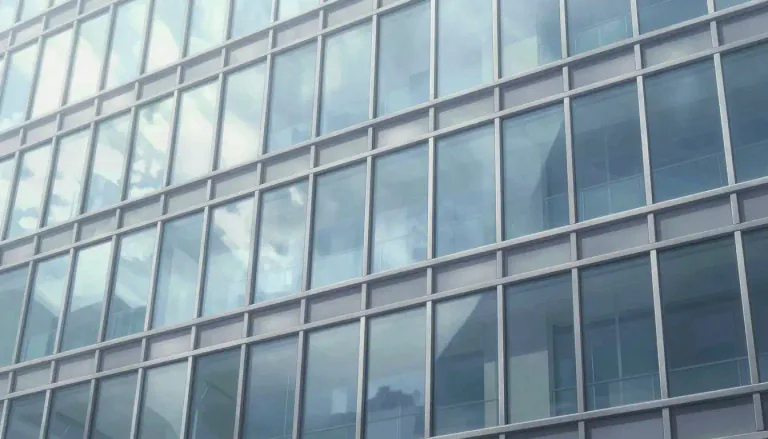 Visual representation of "cladding" - A material that is used to cover the exterior of a building for insulation and aesthetic purposes.