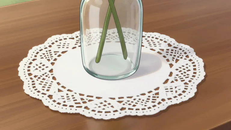 Visual representation of "doily" - A small decorative mat, usually made of paper or fabric, often with a pattern, used to protect surfaces or enhance decoration.
