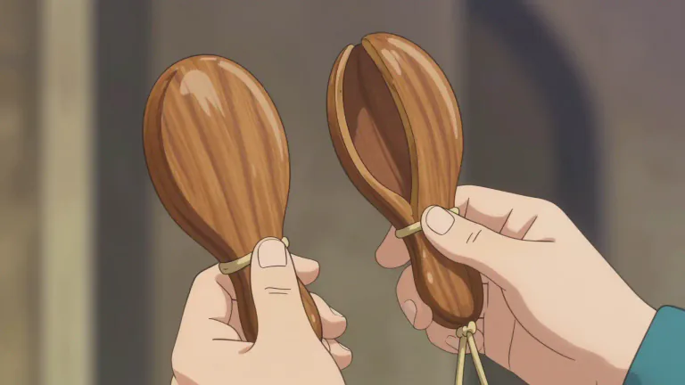 Visual representation of "castanet" - A castanet is a musical instrument made of two pieces of wood joined together, typically played by snapping them together with the fingers, primarily used in dance and music, especially in Flamenco.