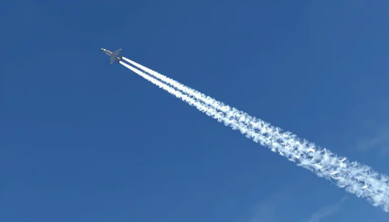 Visual representation of "contrail" - A white streak that is left in the sky by an aircraft flying at high altitude, made of frozen water vapor.