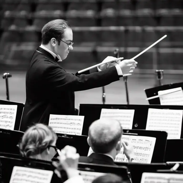 Visual representation of "baton" - A device that holds the music for a conductor